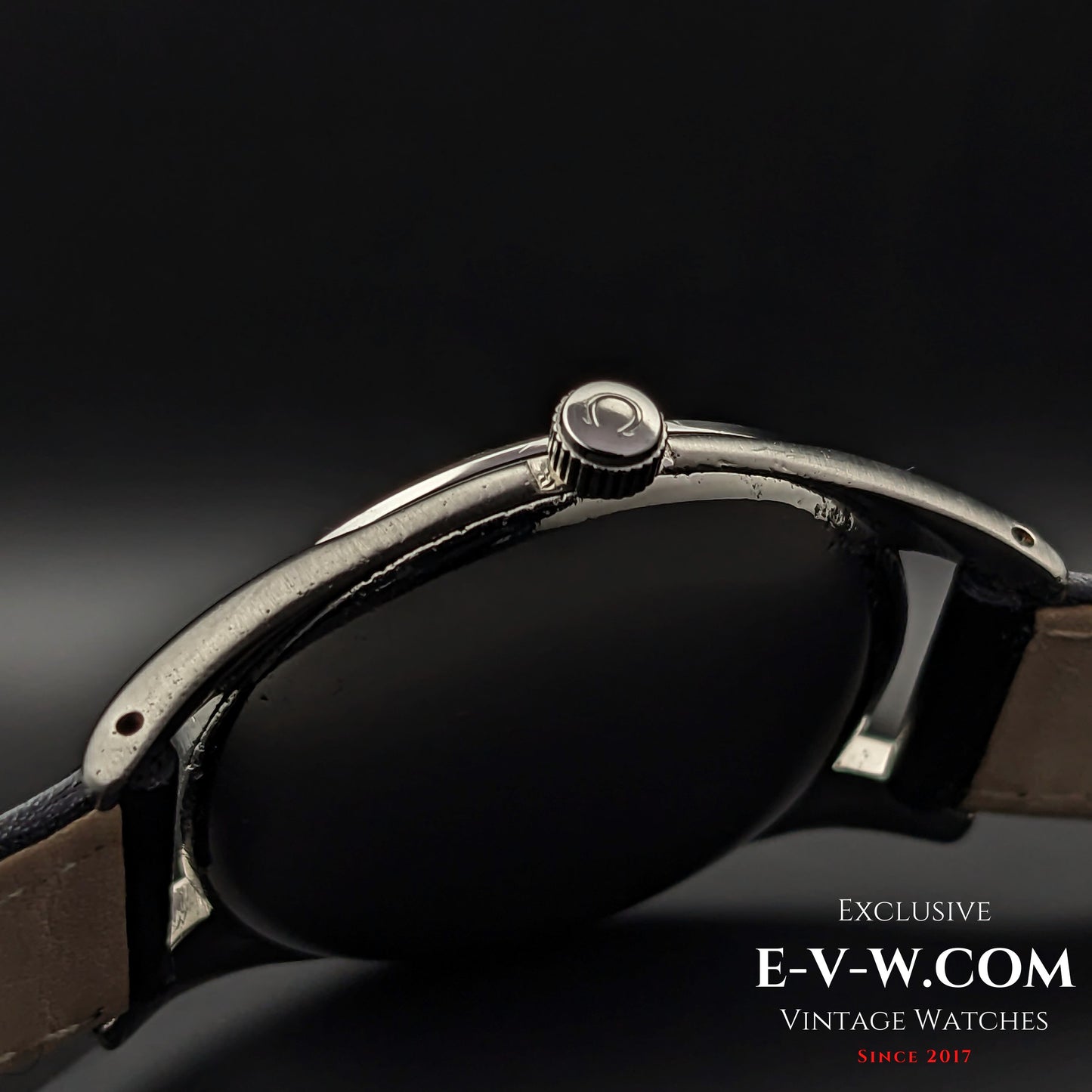 Side view of the Omega Sector Jumbo vintage wristwatch, highlighting the signed Omega crown and polished stainless steel case.