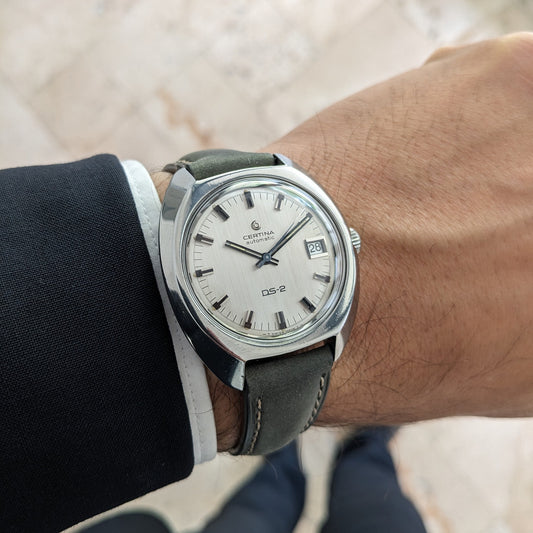 Certina DS-2 Automatic reference 5801 300 on a wrist, showing a silver dial, baton markers, date window, and dark stitched strap.