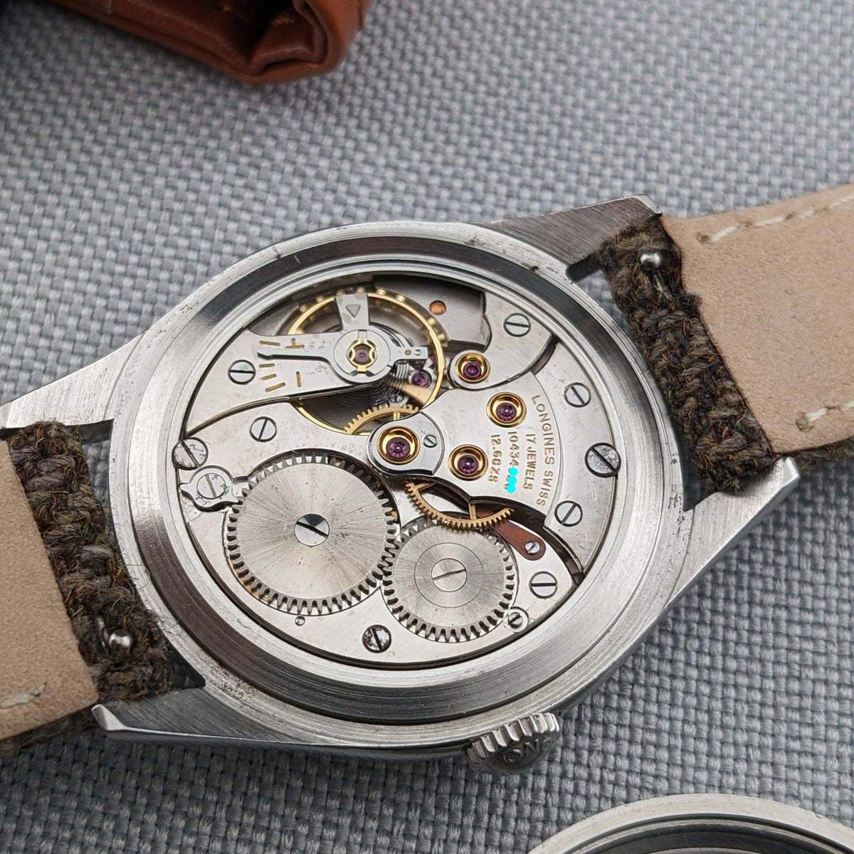 Close-up of the exposed mechanical movement in the Longines Classic reference 8135-5, with gears, bridges, jewels and engraved markings visible.