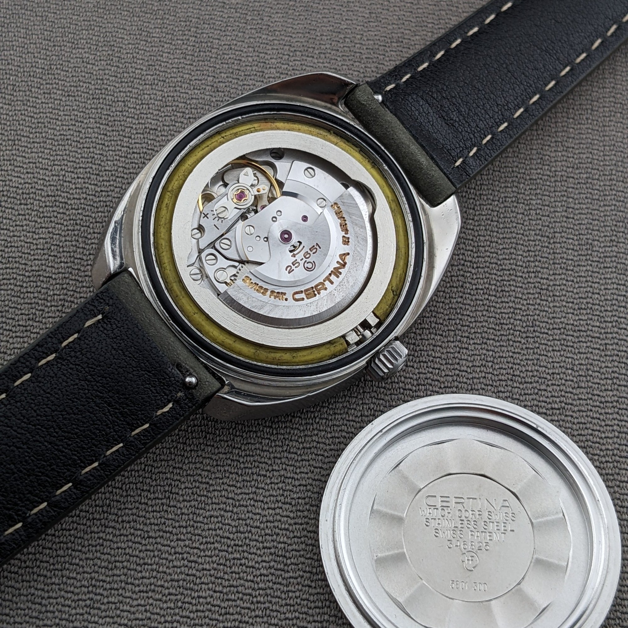 Certina DS-2 Automatic reference 5801 300 shown open from the back beside its detached caseback, with the visible movement and strap.
