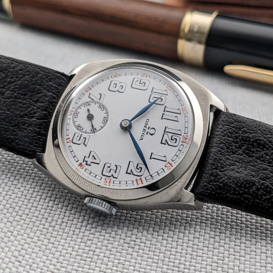 Antique Omega Art Deco steel wristwatch, close front detail showing original dial, blued hands and black leather strap.