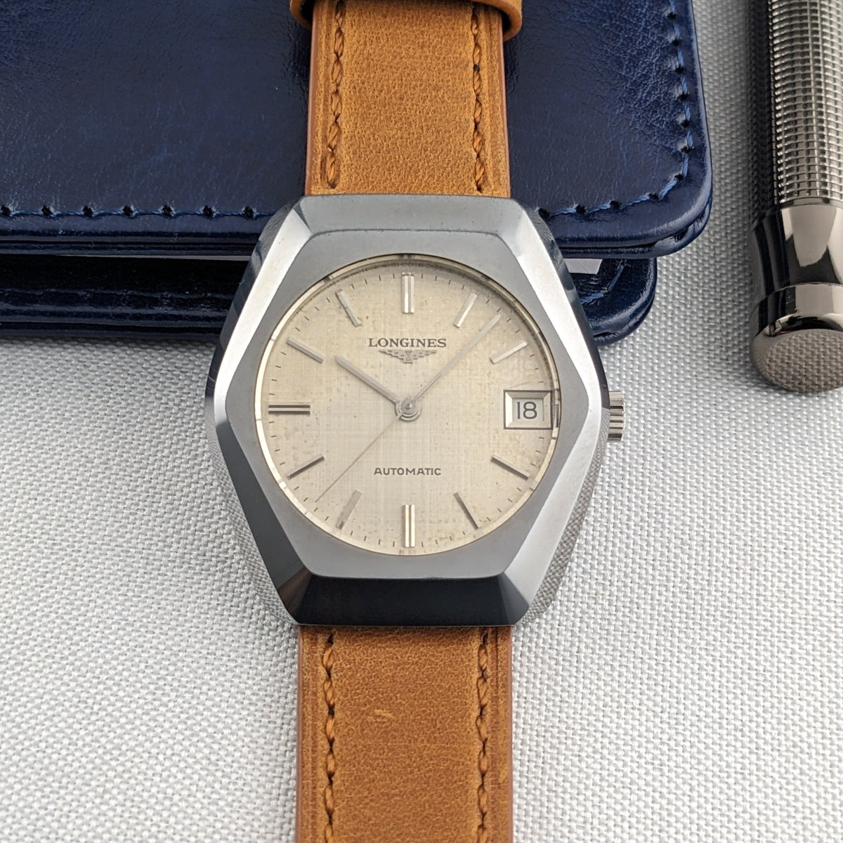 Front view of the LONGINES Automatic reference 3042-633 with cream dial, applied hour markers, date window showing 18 and brown strap.