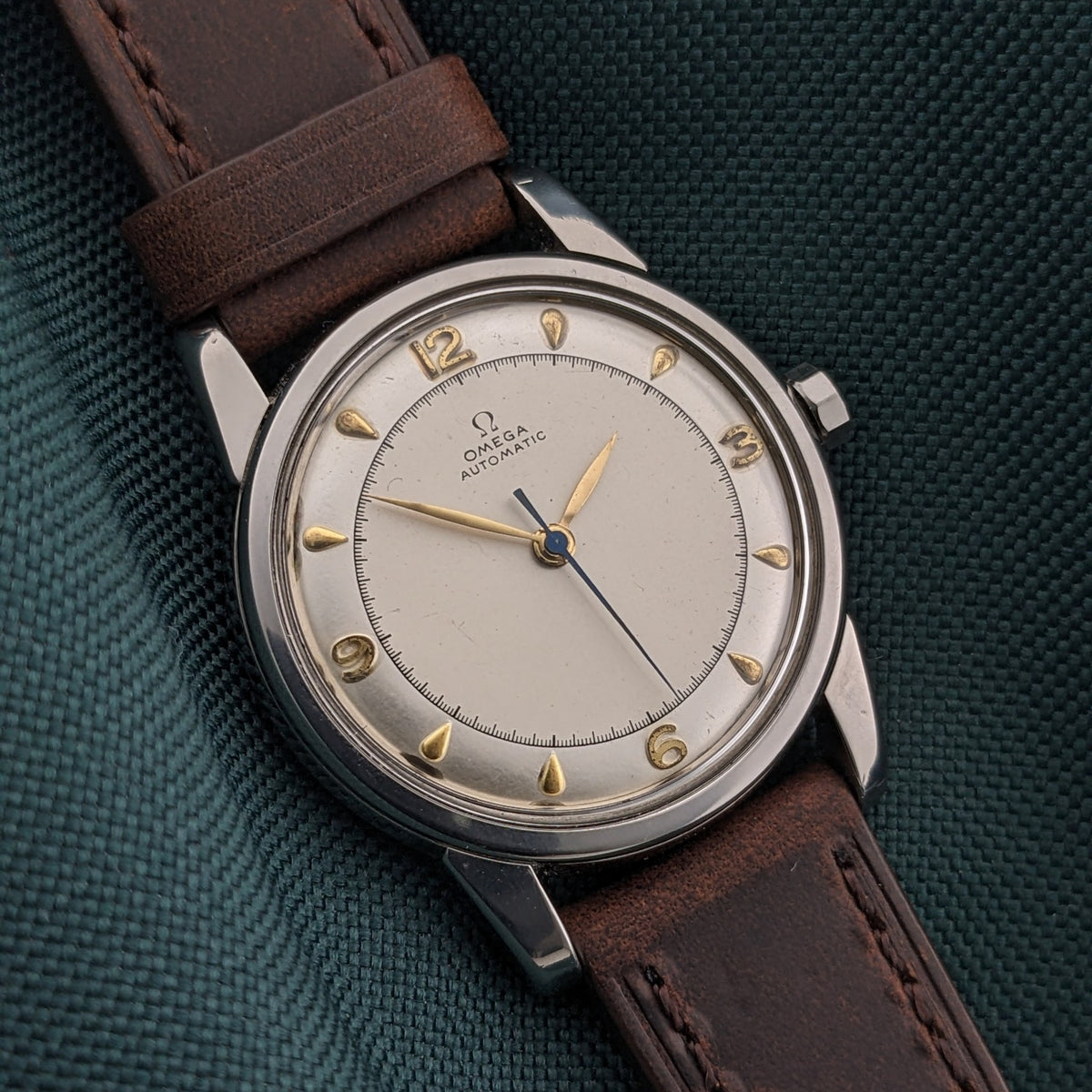 Omega Automatic Bumper reference 2767-4 SC shown dial-up with a cream dial, gold-tone Arabic numerals and teardrop hour markers.