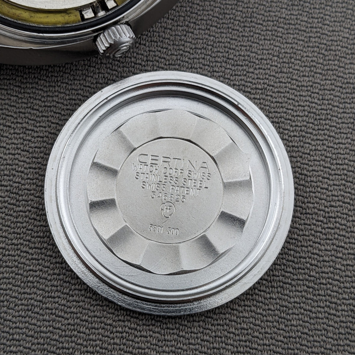 Close-up of the detached Certina caseback for reference 5801 300, showing engraved Certina, DS, Swiss, and reference markings.