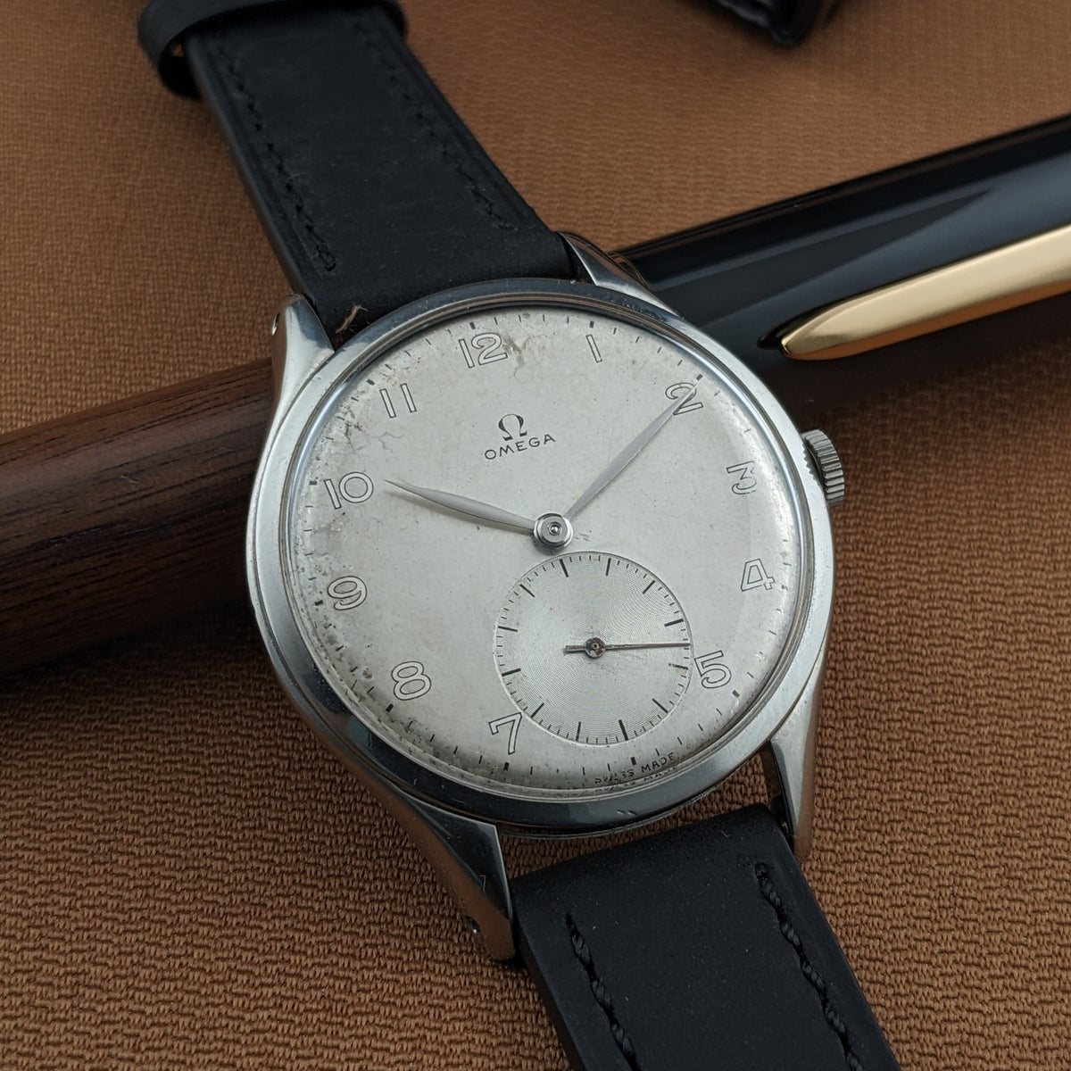 Close view of the Omega Jumbo reference 2505-5 dial with Arabic numerals, Omega logo, small-seconds subdial, and black strap.