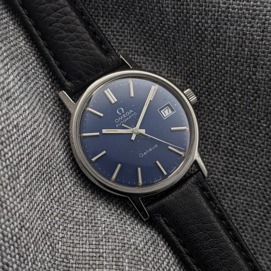 Close view of the Omega Geneve Automatic reference 166.0163 blue dial, showing Omega branding, date window, silver hands and black strap.