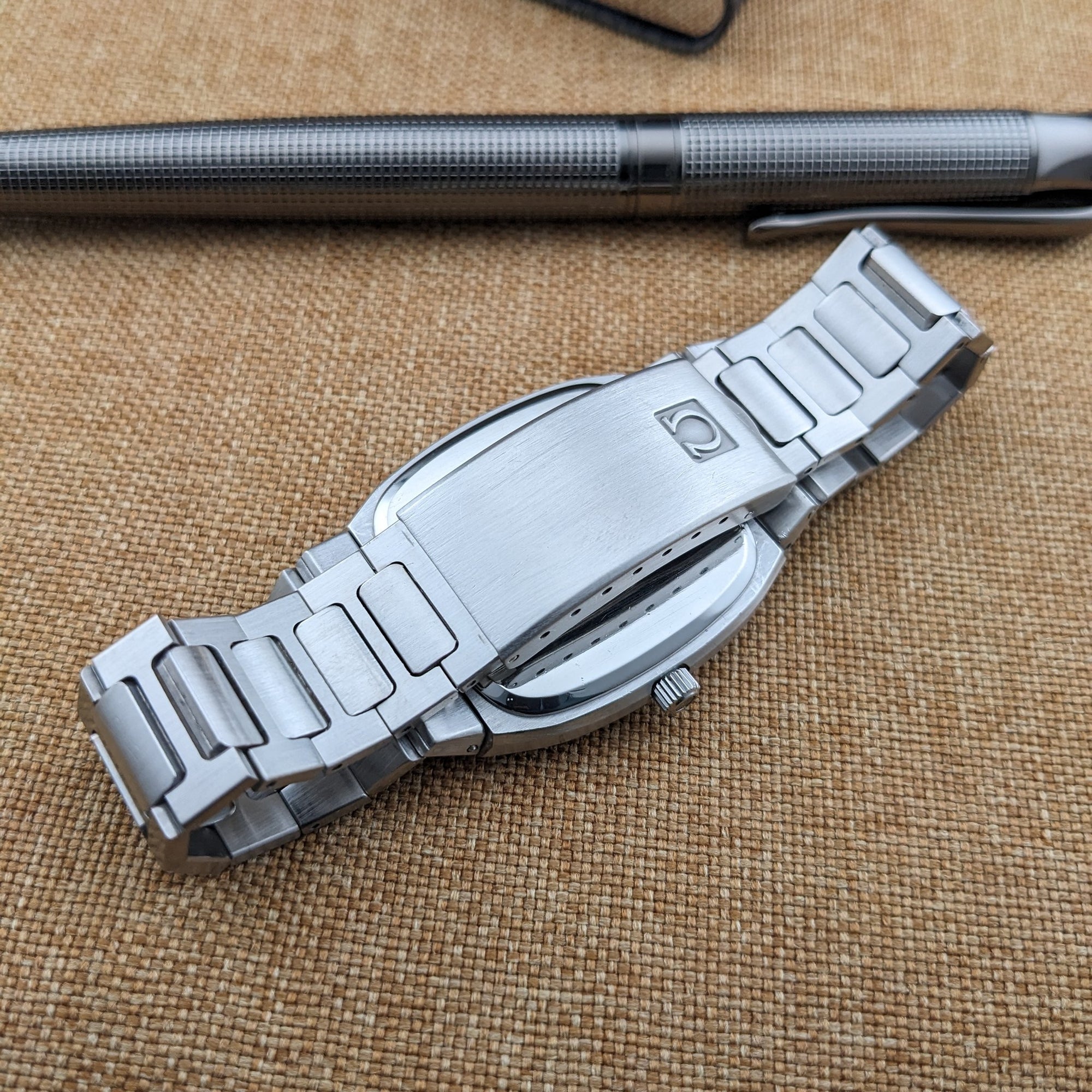Reverse view of the Omega Seamaster reference 196.0166 bracelet showing its broad folding clasp, case underside, and crown.