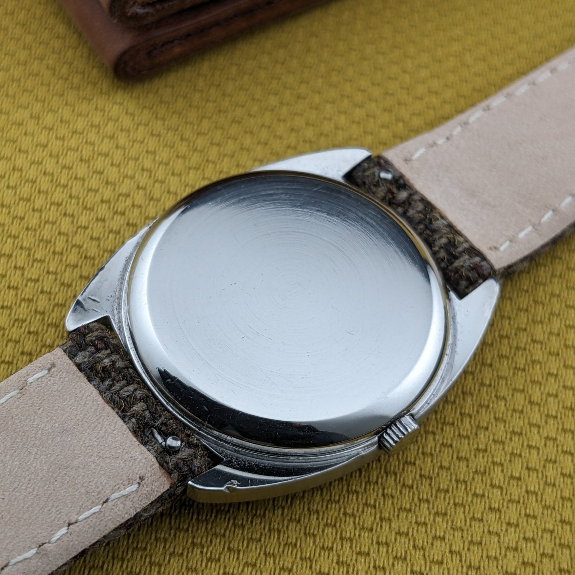 Rear view of the Omega Dr Ville Automatic ref. 162.045, showing its plain polished caseback, crown, and light strap underside.