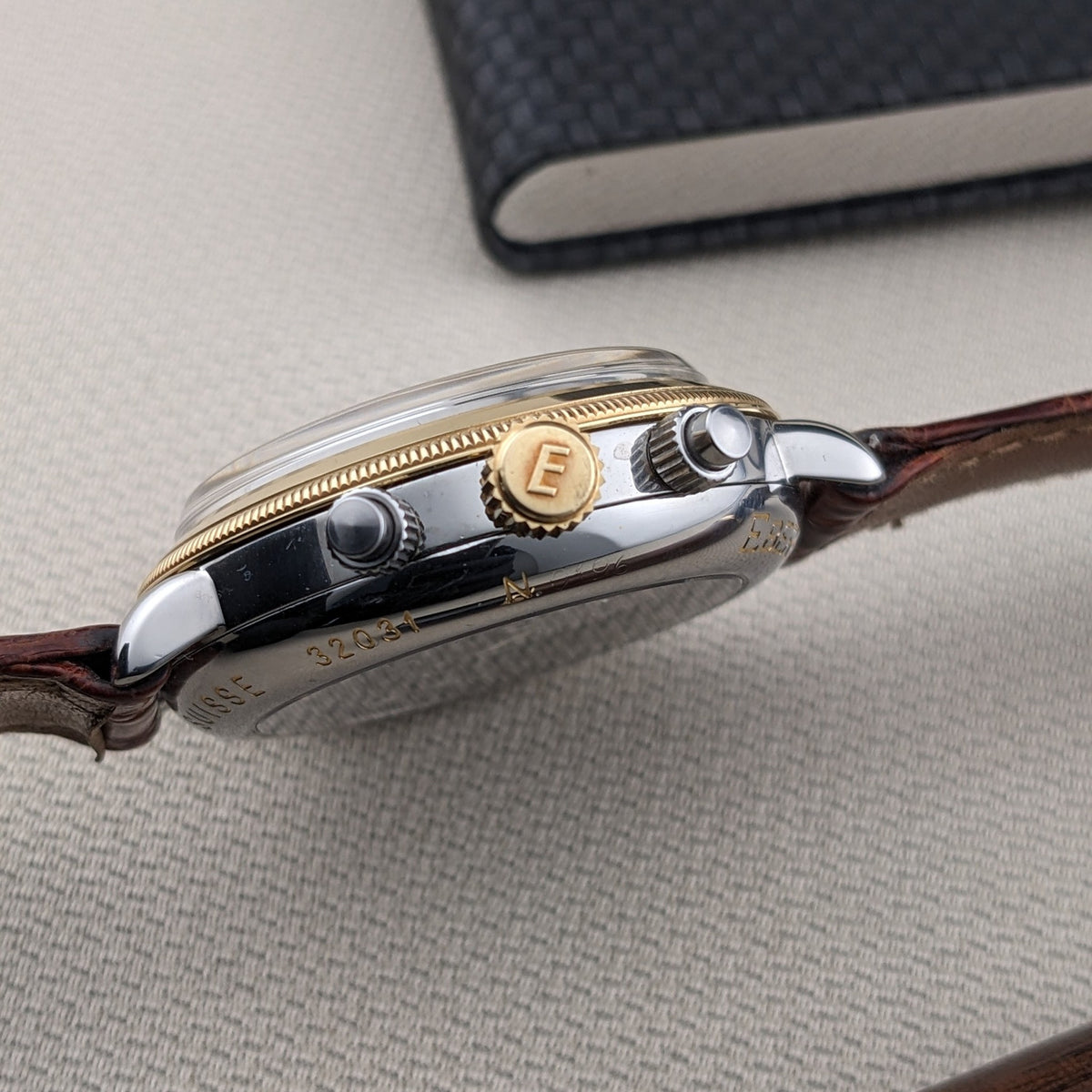 Side profile of the Eberhard & Co. Godron Chrono reference 32031, showing the polished case, crown, pushers and engraved case side.