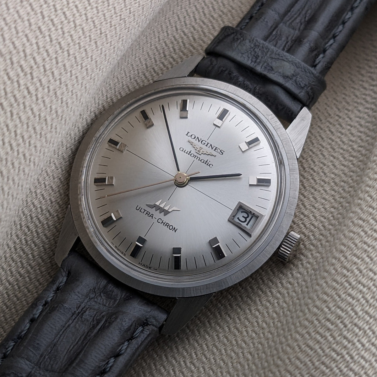 Close-up of the Longines Ultra-Chron 7827 dial showing Longines, automatic, Ultra-Chron text, raised markers, hands, and date window.