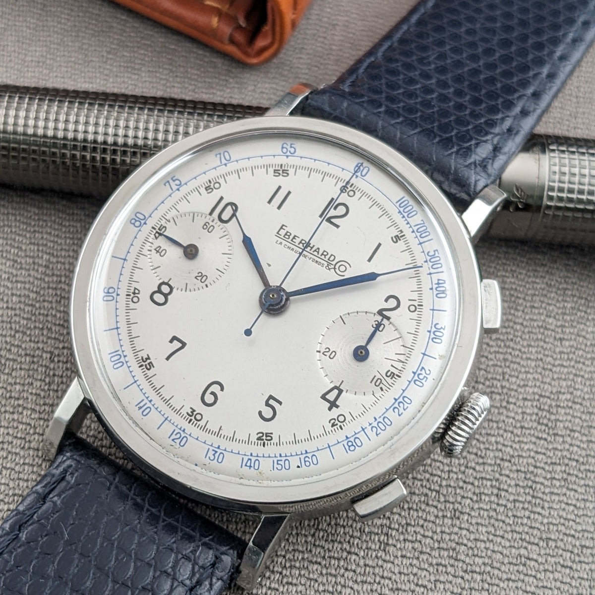 Close-up of the Eberhard & Co. Pre-Extra Fort face with blue hands, black Arabic numerals, twin subdials and blue perimeter scales.