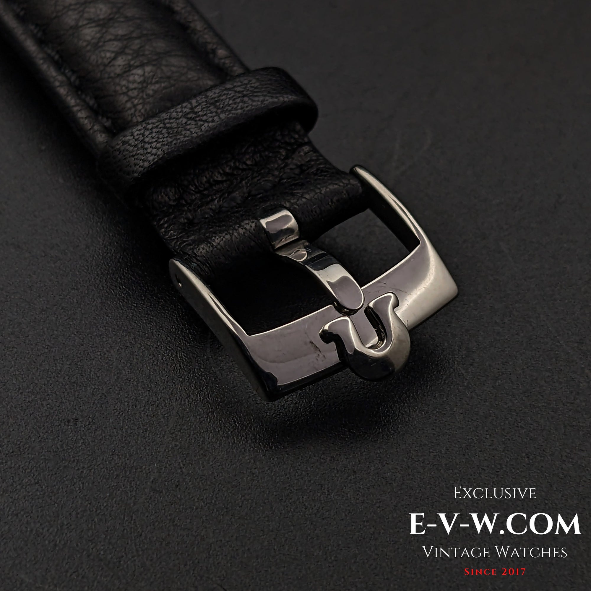 Close-up of the black leather strap and stainless steel buckle of the Omega Jumbo 38mm Ref. 2505 20, featuring a vintage Omega logo.