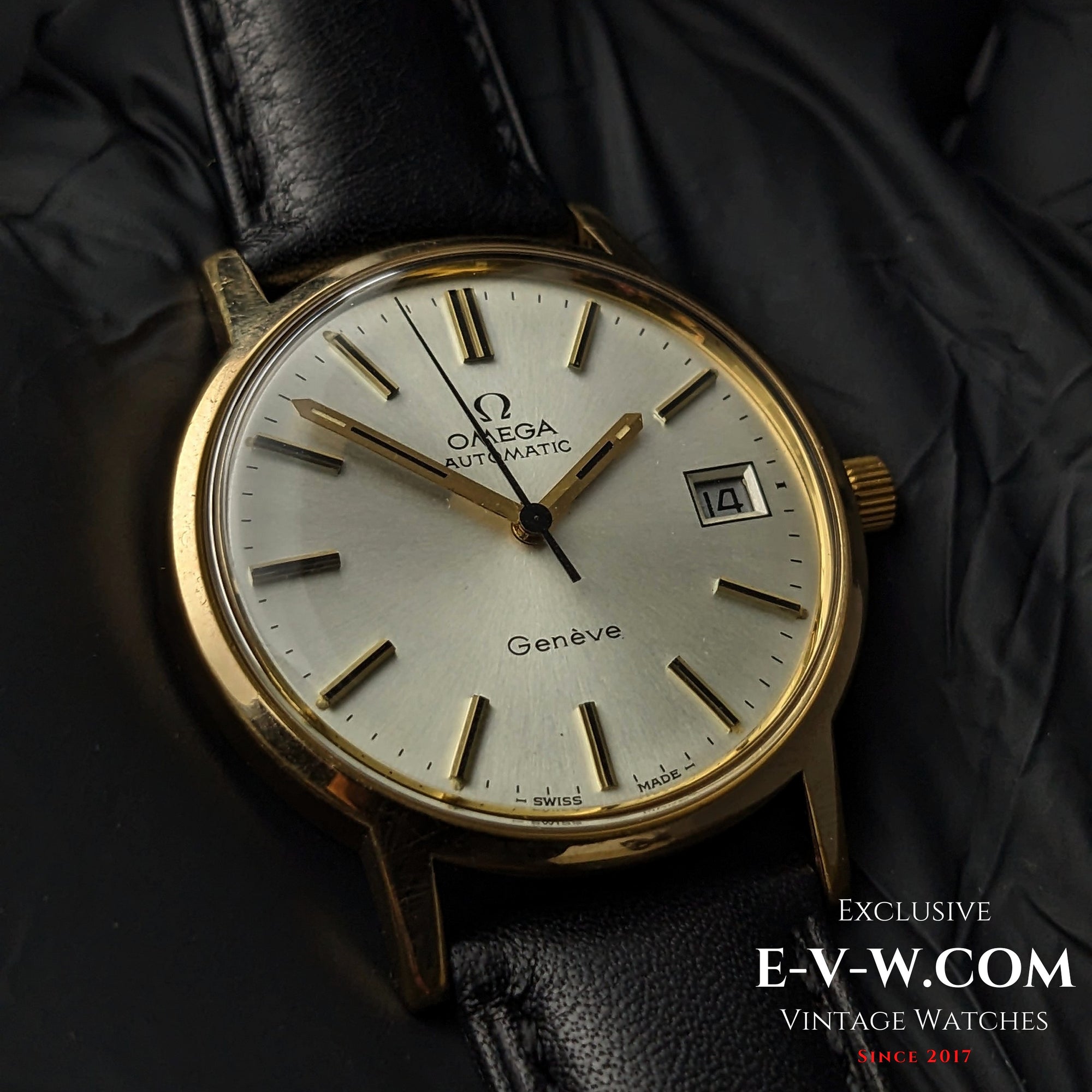 Vintage Omega Geneve 1973 Watch - Ref. 1660163 with gold case, silver dial, and black leather strap, showcasing Swiss automatic craftsmanship.