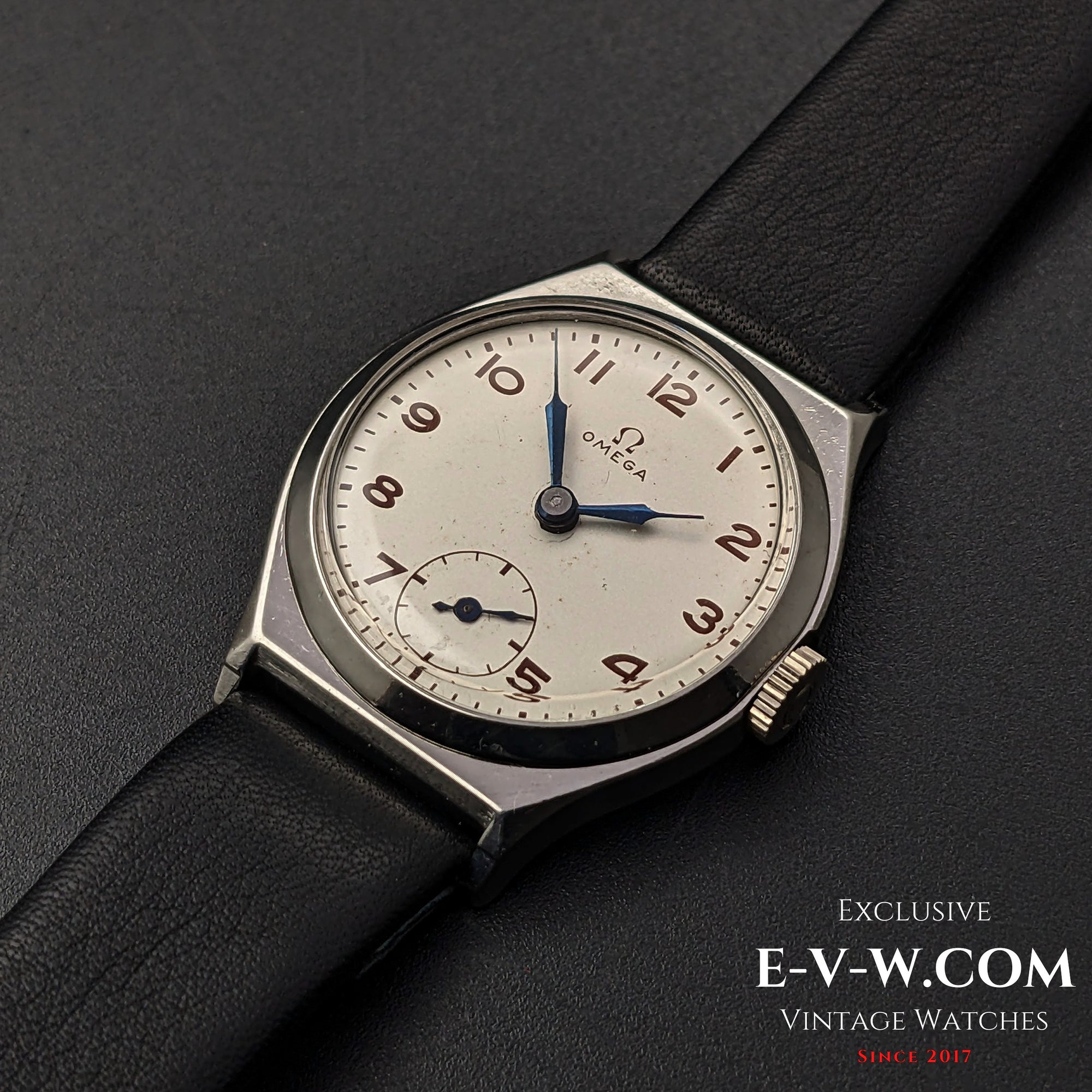 Classic Omega Art Deco wristwatch from 1935 with a silver dial, blue hands, and a black leather strap, featuring Cal. 26.5SOBT2 movement.