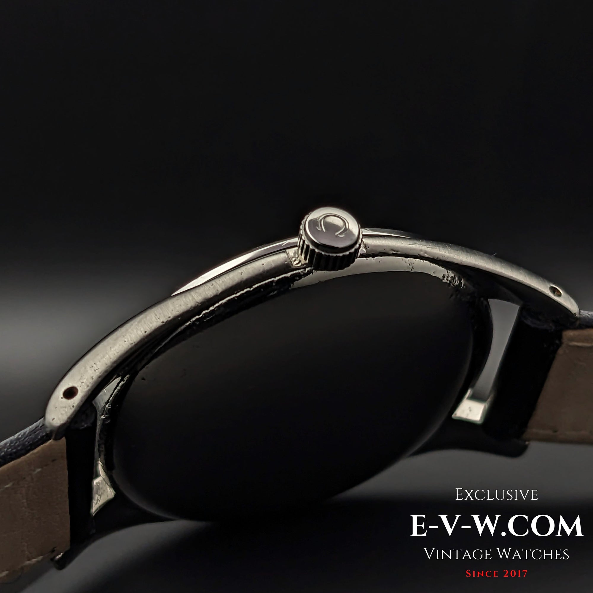 Side view of the Omega Sector Jumbo vintage wristwatch, highlighting the signed Omega crown and polished stainless steel case.