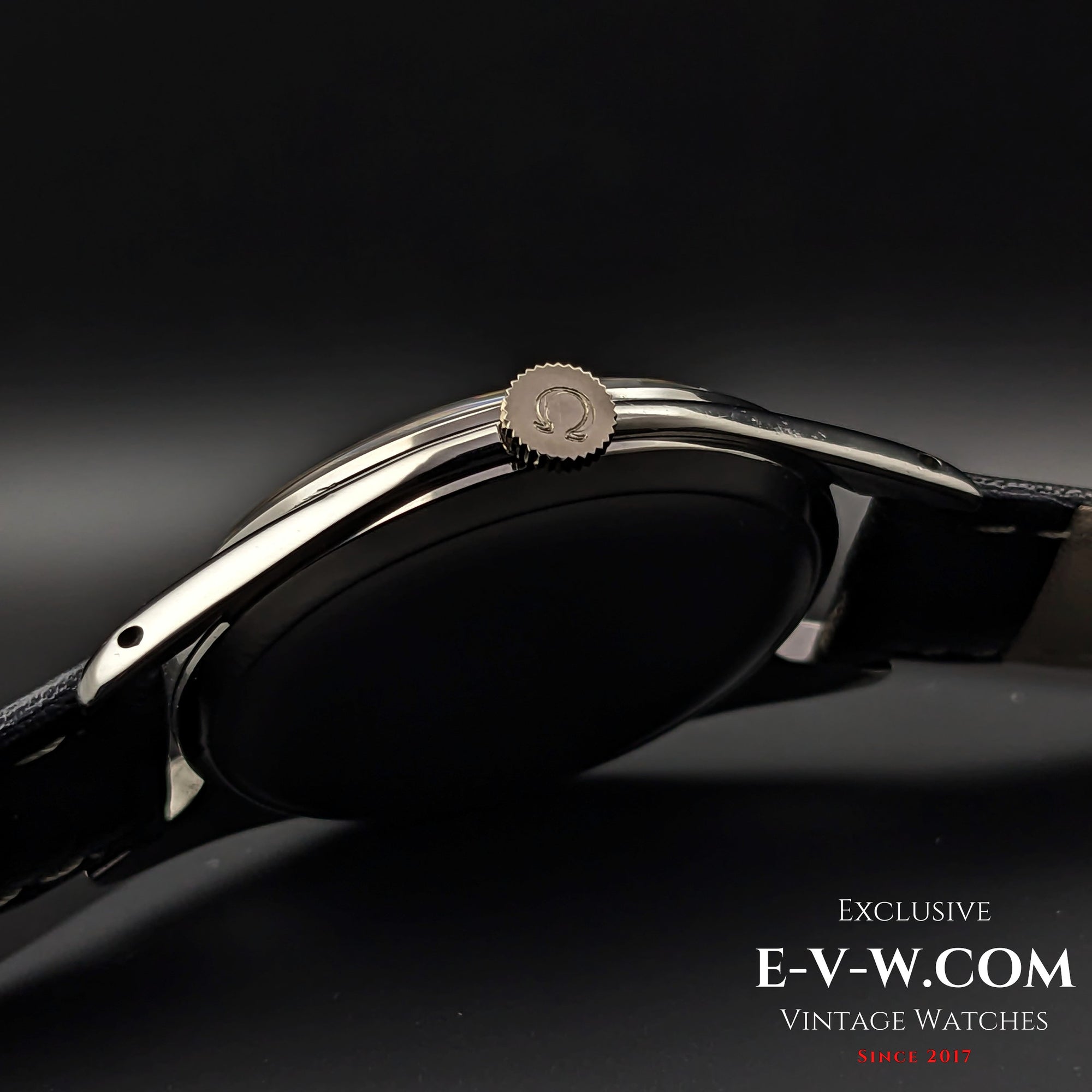 Crown view of Omega Jumbo 38mm Ref. 2505 20, featuring the Omega logo on the crown and a polished stainless steel case with a black leather strap.