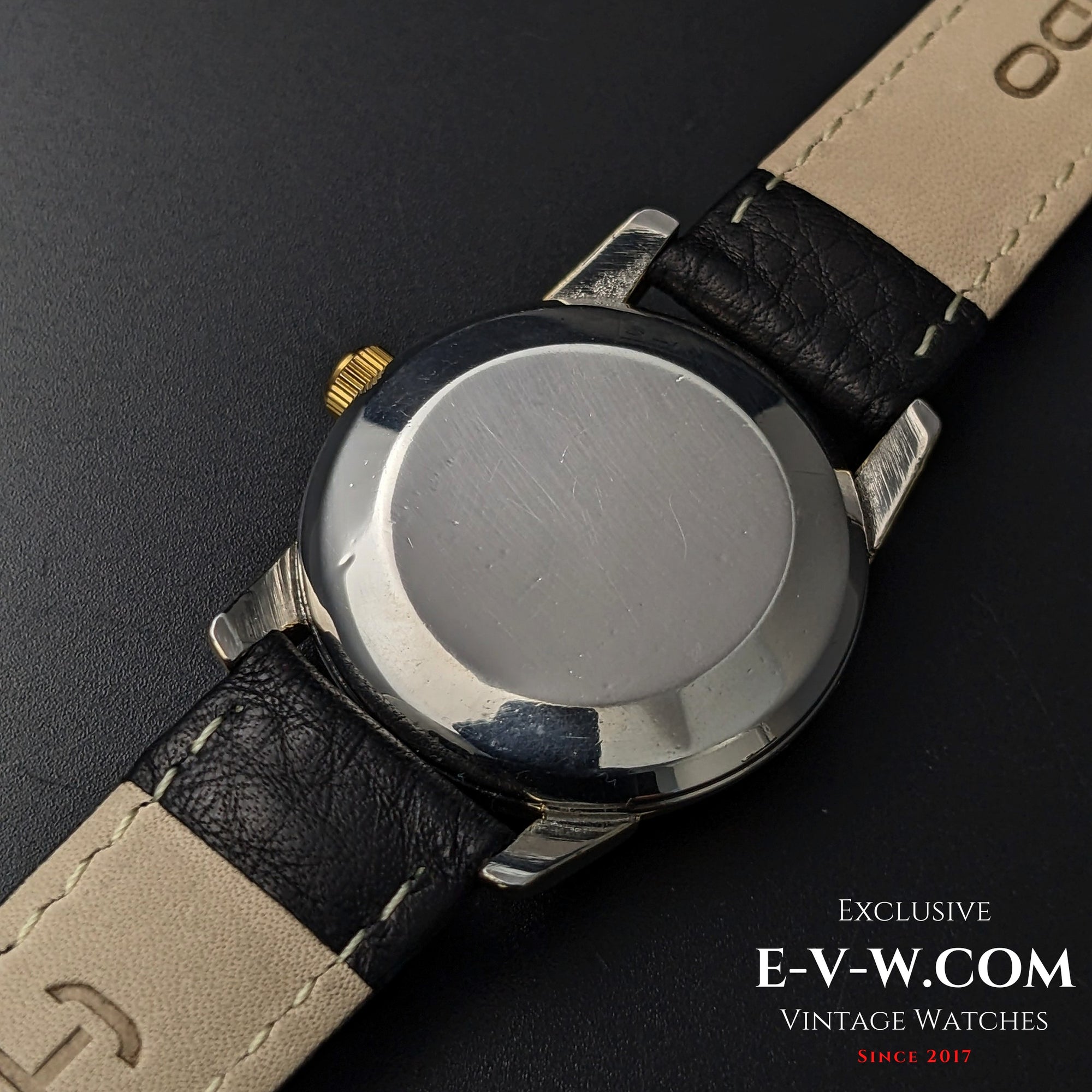Back case of Omega Seamaster Ref. 2828-9SC Cal. 471 showing polished stainless steel surface and black leather strap.